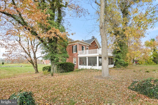 exterior space featuring a balcony and a sunroom