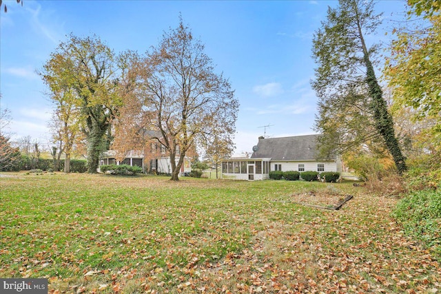 view of yard with a sunroom