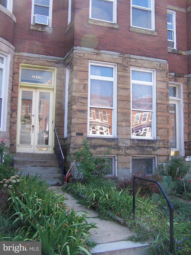 entrance to property featuring french doors and cooling unit