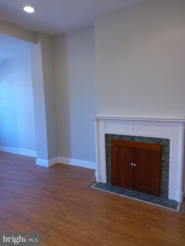 unfurnished living room featuring dark hardwood / wood-style floors