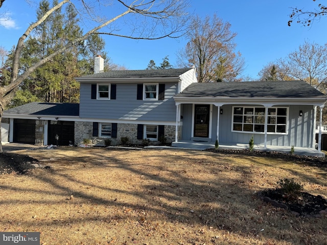 split level home with a garage and a front lawn