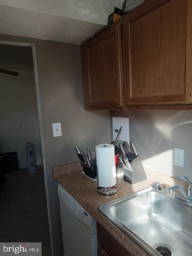 kitchen featuring white dishwasher and sink