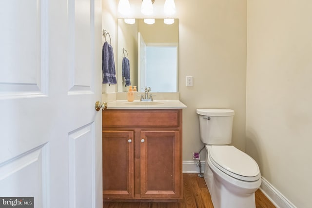 bathroom featuring hardwood / wood-style floors, vanity, and toilet