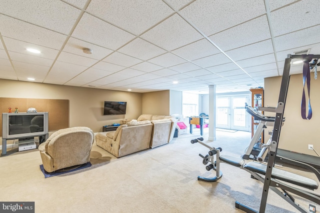 workout room featuring carpet and a drop ceiling