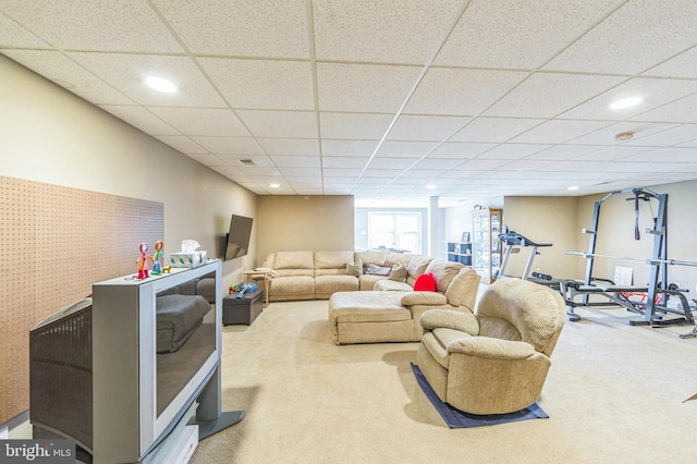 carpeted living room featuring a paneled ceiling