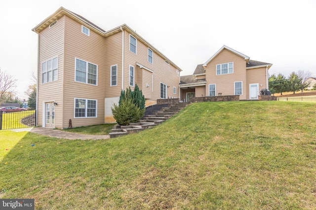 rear view of house with a yard