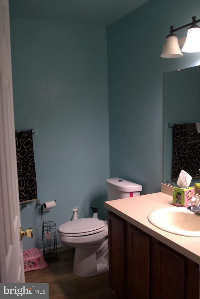 bathroom featuring hardwood / wood-style floors, vanity, and toilet