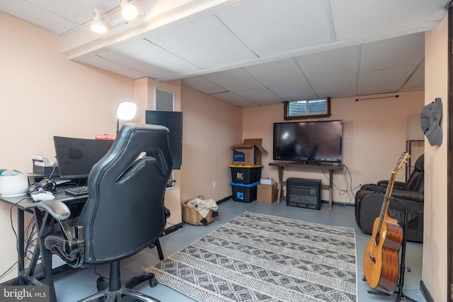 office space with a drop ceiling and concrete flooring