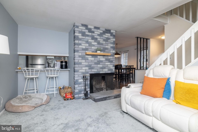 living room featuring carpet flooring and a fireplace