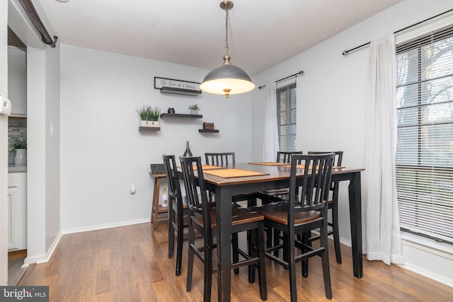 dining space with dark hardwood / wood-style floors