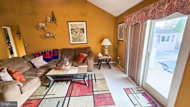 carpeted living room featuring vaulted ceiling