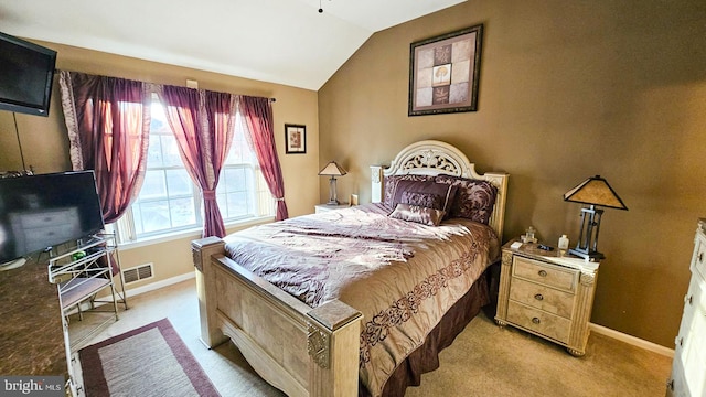 carpeted bedroom with vaulted ceiling