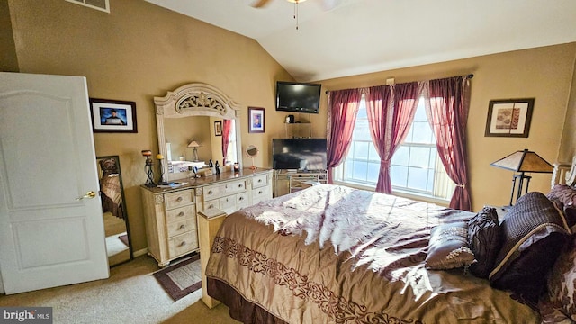 carpeted bedroom featuring vaulted ceiling and ceiling fan