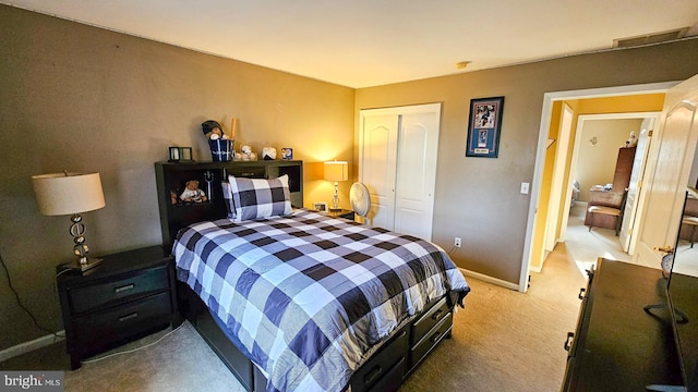 carpeted bedroom with a closet