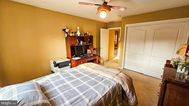 carpeted bedroom with a closet and ceiling fan