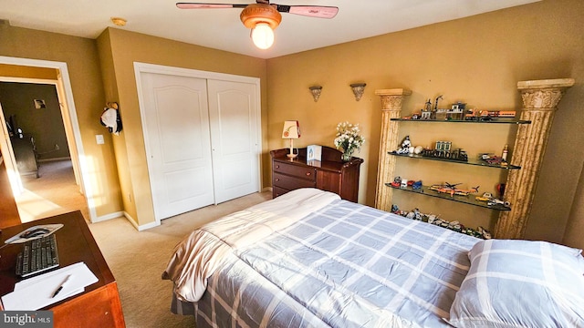 bedroom featuring carpet, ceiling fan, and a closet