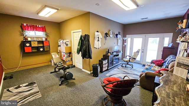 exercise area featuring carpet and french doors