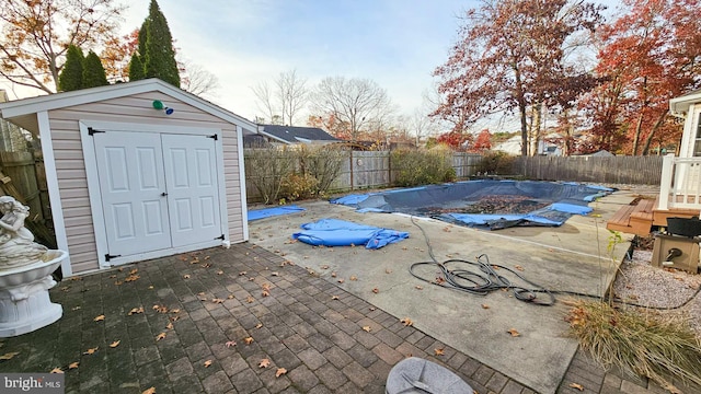 view of patio featuring a shed and a covered pool