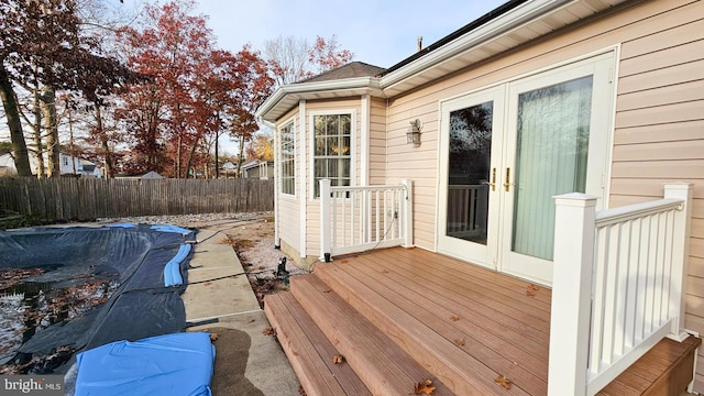 wooden deck featuring a covered pool