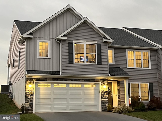 view of front of home featuring central AC and a garage