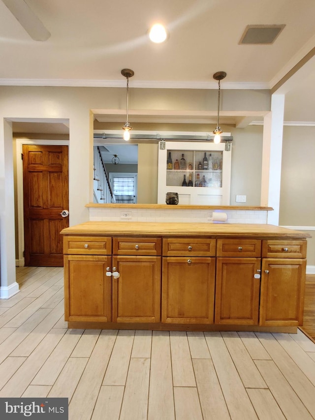 kitchen featuring light hardwood / wood-style floors and hanging light fixtures