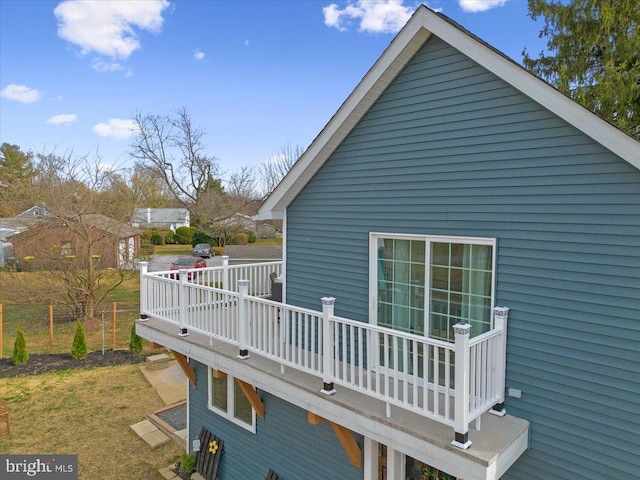 view of property exterior with a lawn and a wooden deck