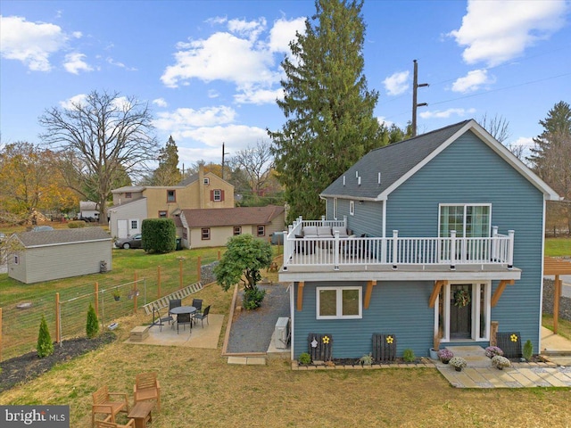 back of house featuring a yard, a patio, and a deck