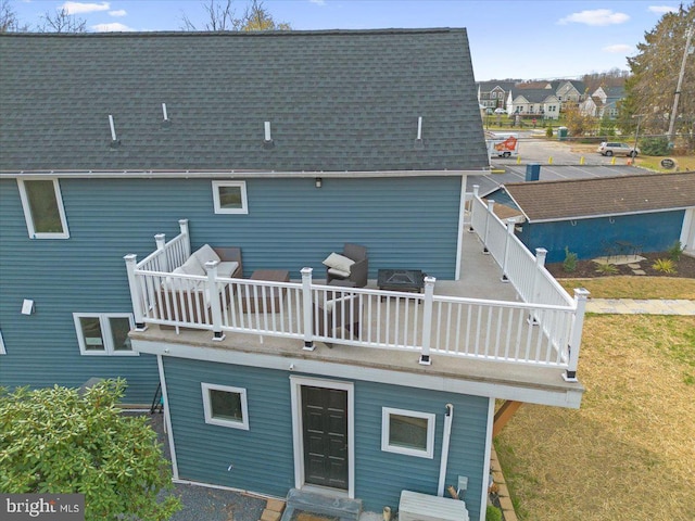 back of property featuring a wooden deck