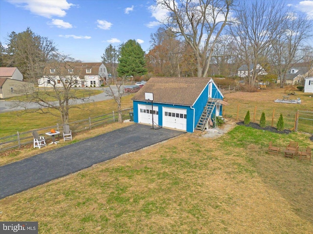 exterior space with a garage and an outdoor structure