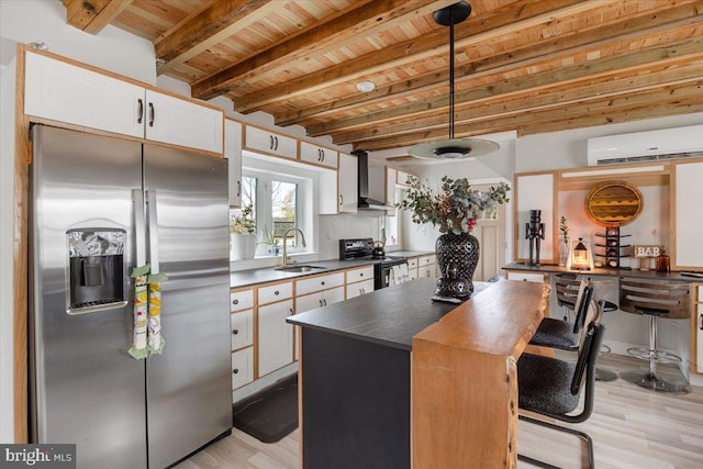 kitchen featuring black / electric stove, white cabinets, pendant lighting, and stainless steel refrigerator with ice dispenser