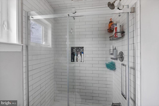 bathroom with a shower with shower door