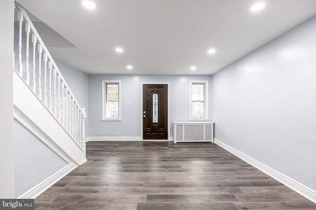 foyer featuring dark hardwood / wood-style flooring and radiator heating unit