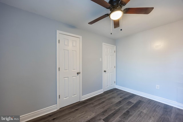 unfurnished bedroom featuring dark hardwood / wood-style flooring and ceiling fan