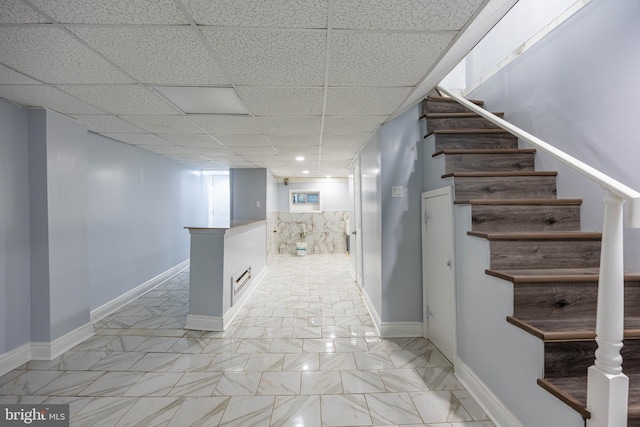 corridor with a paneled ceiling