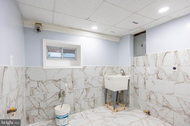 bathroom with electric panel and tile walls