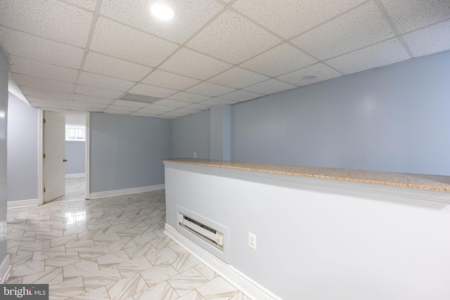 interior space featuring bar area and a paneled ceiling