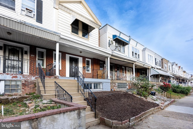 townhome / multi-family property featuring a porch