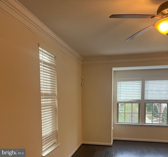 empty room with ceiling fan, ornamental molding, and dark wood-type flooring