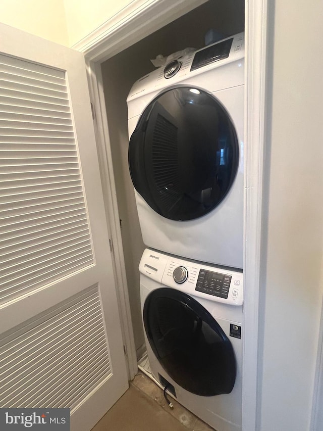 laundry area with stacked washer and dryer