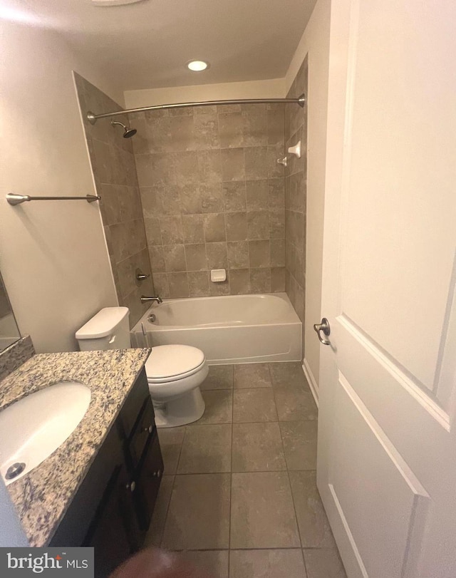 full bathroom featuring tile patterned floors, vanity, toilet, and tiled shower / bath