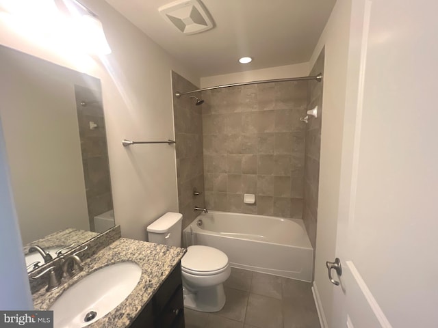 full bathroom featuring tile patterned floors, tiled shower / bath combo, toilet, and vanity