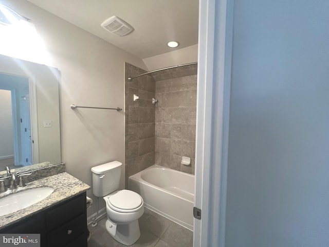 full bathroom with tile patterned floors, tiled shower / bath, vanity, and toilet