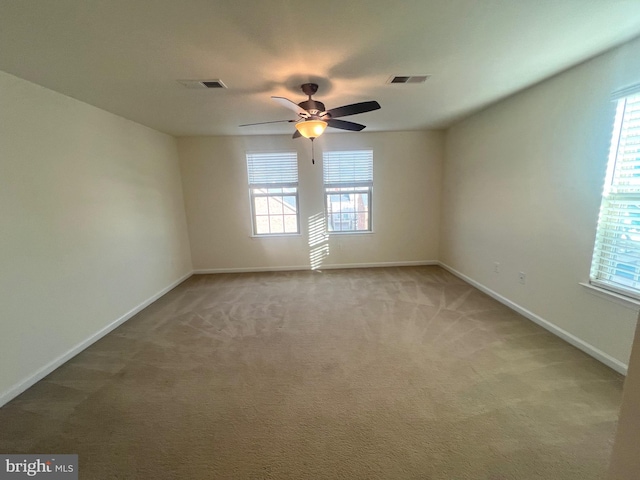 spare room featuring carpet flooring and ceiling fan