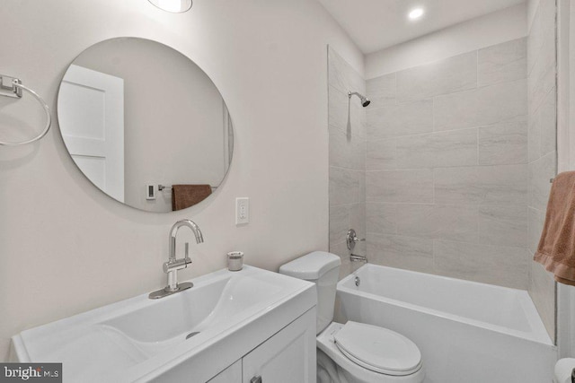 full bathroom with vanity, toilet, and tiled shower / bath