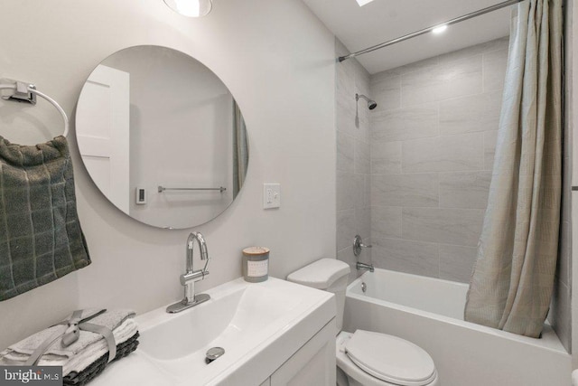 full bathroom featuring toilet, shower / tub combo with curtain, and sink