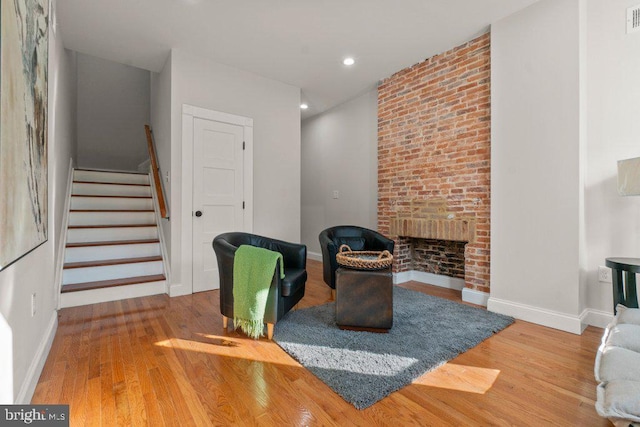 living area with a fireplace and hardwood / wood-style floors