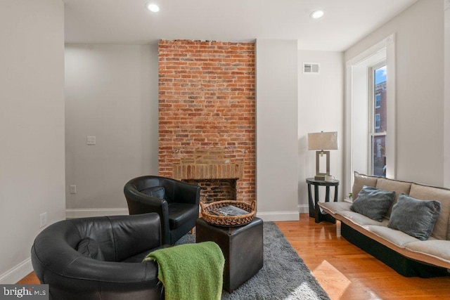 living room featuring a fireplace and light hardwood / wood-style flooring