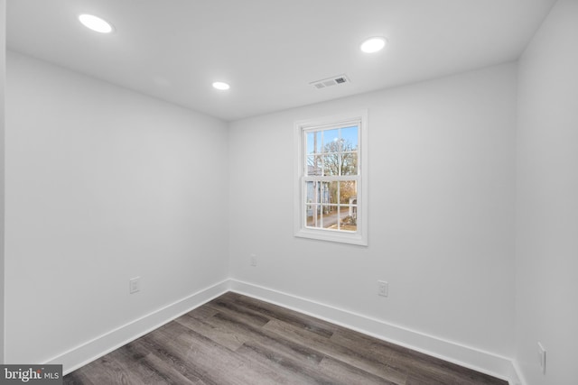 empty room featuring dark wood-type flooring