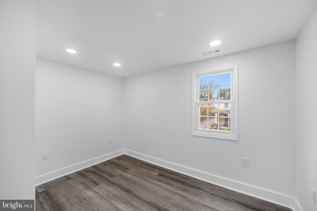 unfurnished room featuring dark hardwood / wood-style floors