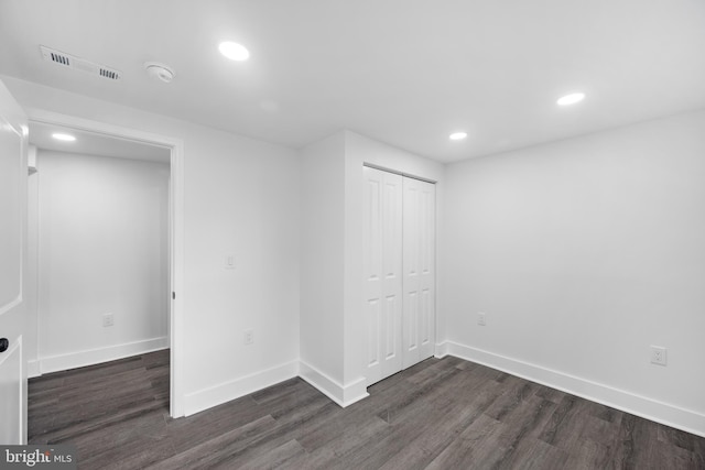 interior space with dark hardwood / wood-style flooring and a closet